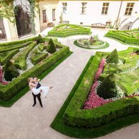 Ksenia & Mark - wedding ceremony in Old town Hall - Kissing Wedding Couple in Prague Garden